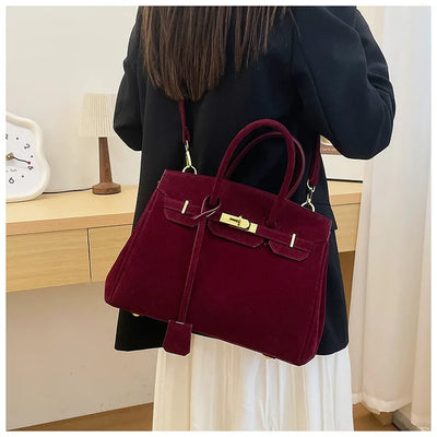Kelly | Borsa a tracolla in camoscio con ferrature dorate